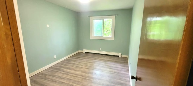 5374 36th Ave Unit 38, Hudsonville, MI 49426 - empty room featuring baseboard heating, baseboards, and wood finished floors