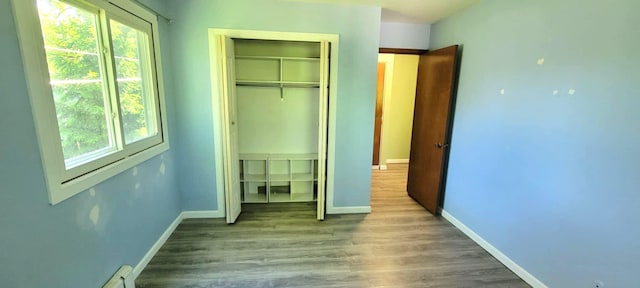 5374 36th Ave Unit 38, Hudsonville, MI 49426 - unfurnished bedroom with multiple windows, a closet, wood finished floors, and baseboards