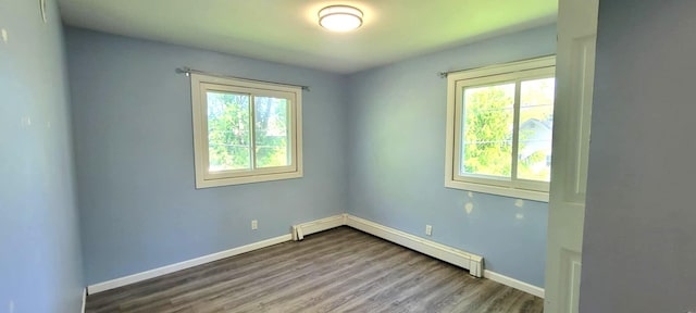 5374 36th Ave Unit 38, Hudsonville, MI 49426 - spare room featuring baseboards, wood finished floors, and a baseboard heating unit
