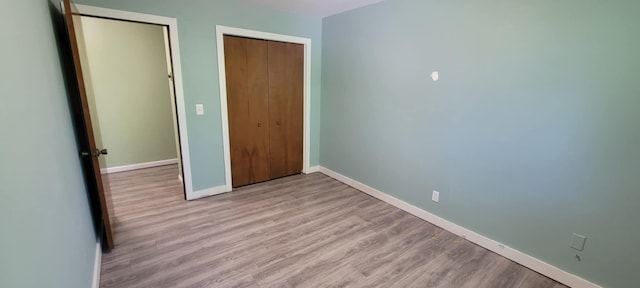5374 36th Ave Unit 38, Hudsonville, MI 49426 - unfurnished bedroom featuring baseboards, a closet, and light wood-style floors
