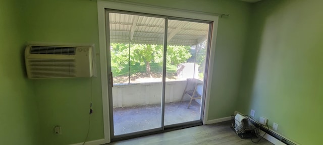 5374 36th Ave Unit 38, Hudsonville, MI 49426 - entryway with wood finished floors, an AC wall unit, and baseboards