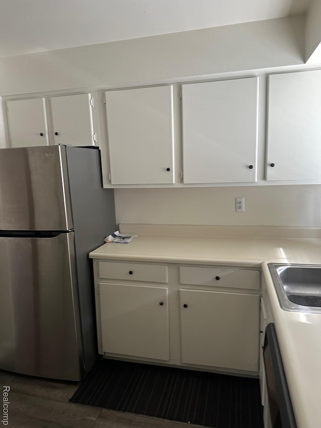 25332 Shiawassee Cir, Southfield, MI 48033 - kitchen with freestanding refrigerator, white cabinetry, dark wood-type flooring, light countertops, and a sink