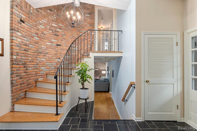 2960 Timberwyck Trail Dr, Troy, MI 48098 - stairs featuring a high ceiling, a chandelier, brick wall, and baseboards