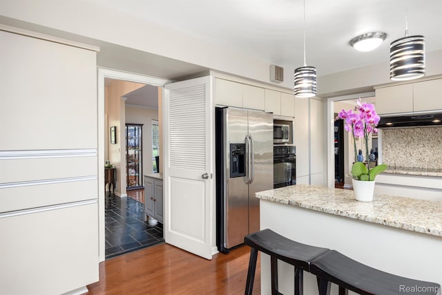 2960 Timberwyck Trail Dr, Troy, MI 48098 - kitchen featuring appliances with stainless steel finishes, under cabinet range hood, white cabinets, pendant lighting, and dark wood finished floors