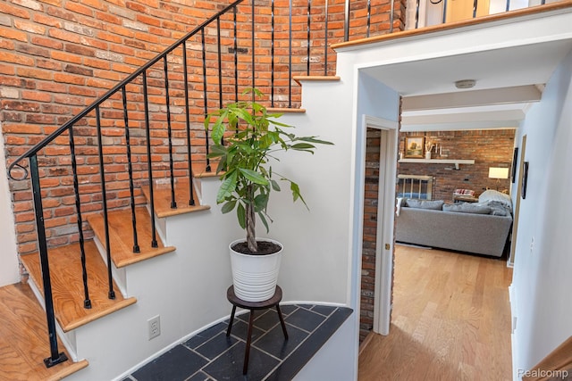 2960 Timberwyck Trail Dr, Troy, MI 48098 - staircase featuring brick wall and wood finished floors
