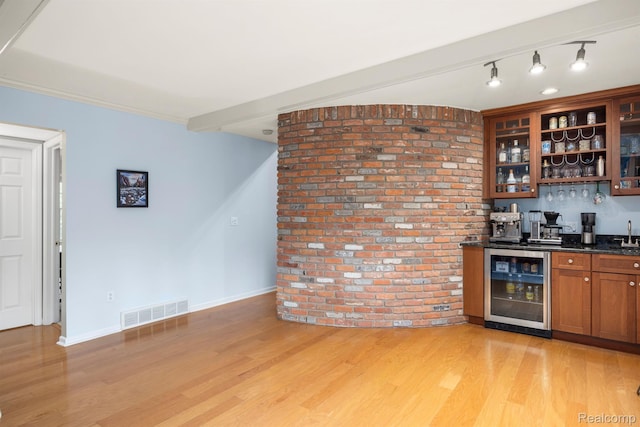 2960 Timberwyck Trail Dr, Troy, MI 48098 - indoor wet bar featuring beverage cooler, brick wall, light wood-type flooring, and baseboards