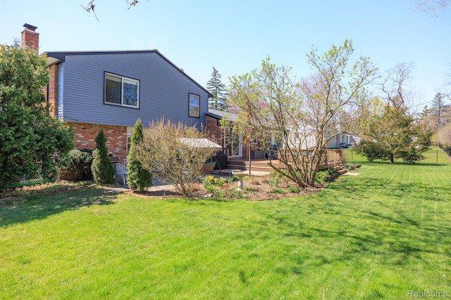 2960 Timberwyck Trail Dr, Troy, MI 48098 - view of side of home featuring a chimney, a yard, brick siding, and a wooden deck