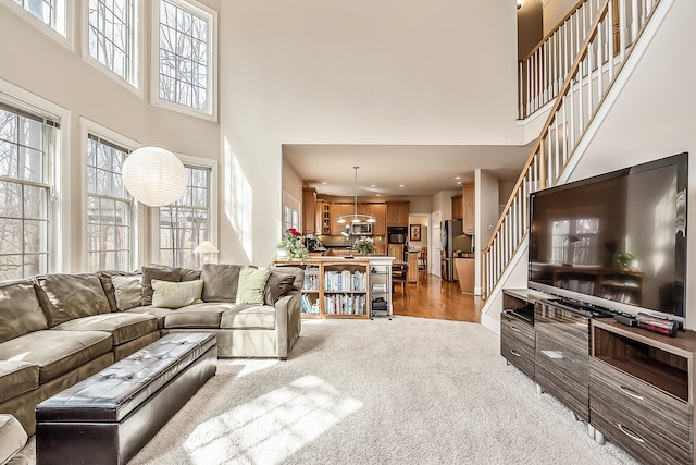 2129 Autumn Hill Dr, Ann Arbor, MI 48103 - living area with a towering ceiling, plenty of natural light, light colored carpet, stairs, and recessed lighting