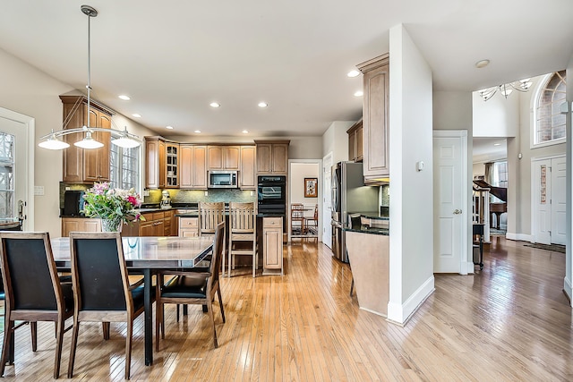 2129 Autumn Hill Dr, Ann Arbor, MI 48103 - dining space featuring light wood-style flooring, healthy amount of natural light, recessed lighting, a chandelier, and baseboards