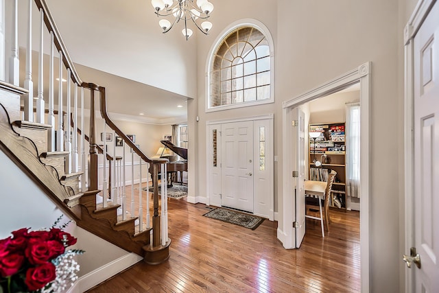 2129 Autumn Hill Dr, Ann Arbor, MI 48103 - entryway featuring a chandelier, stairs, wood-type flooring, baseboards, and a high ceiling