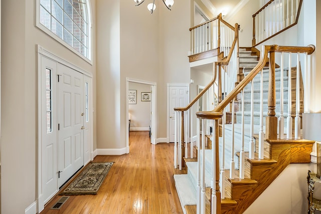 2129 Autumn Hill Dr, Ann Arbor, MI 48103 - entrance foyer featuring a towering ceiling, baseboards, wood finished floors, stairs, and a chandelier