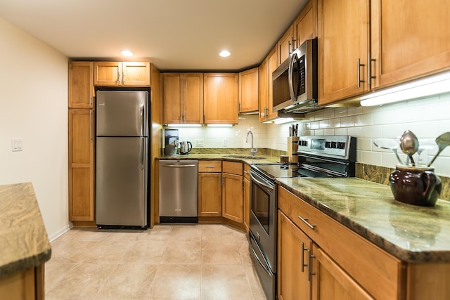 2129 Autumn Hill Dr, Ann Arbor, MI 48103 - kitchen featuring stainless steel appliances, a sink, brown cabinetry, and recessed lighting
