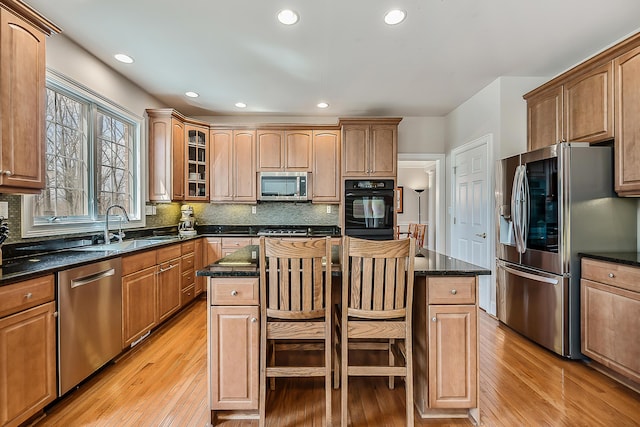 2129 Autumn Hill Dr, Ann Arbor, MI 48103 - kitchen featuring stainless steel appliances, a sink, light wood-style floors, a center island, and recessed lighting