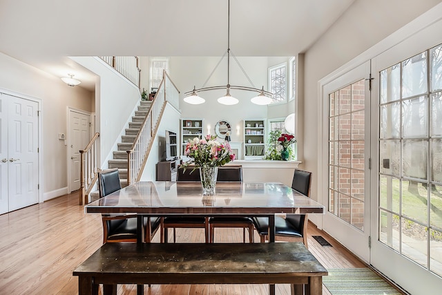 2129 Autumn Hill Dr, Ann Arbor, MI 48103 - dining space featuring light wood finished floors, stairway, and baseboards