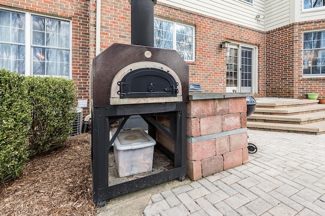 2129 Autumn Hill Dr, Ann Arbor, MI 48103 - exterior view of brick siding and a wood stove