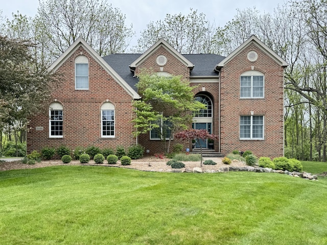 2129 Autumn Hill Dr, Ann Arbor, MI 48103 - georgian-style home with a front yard, brick siding, and roof with shingles