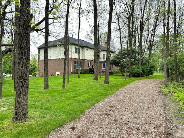 2129 Autumn Hill Dr, Ann Arbor, MI 48103 - view of front facade with brick siding, a front lawn, and a chimney
