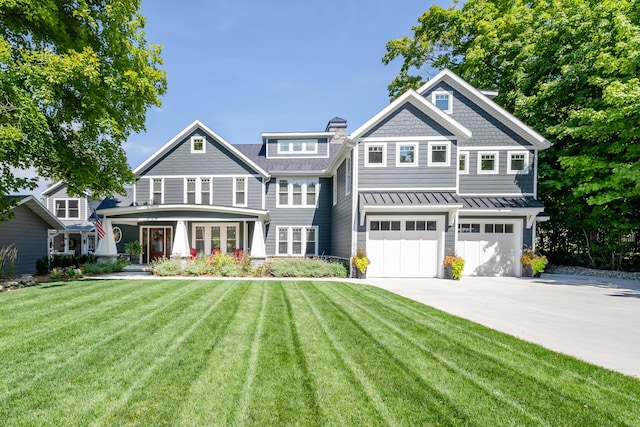 7881 Lakewood Dr, Coloma, MI 49038 - shingle-style home with driveway, a standing seam roof, an attached garage, a front lawn, and metal roof