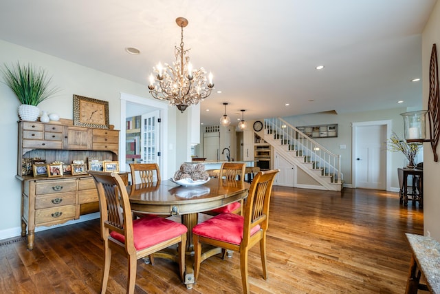 7881 Lakewood Dr, Coloma, MI 49038 - dining room featuring stairs, a chandelier, wood finished floors, recessed lighting, and baseboards