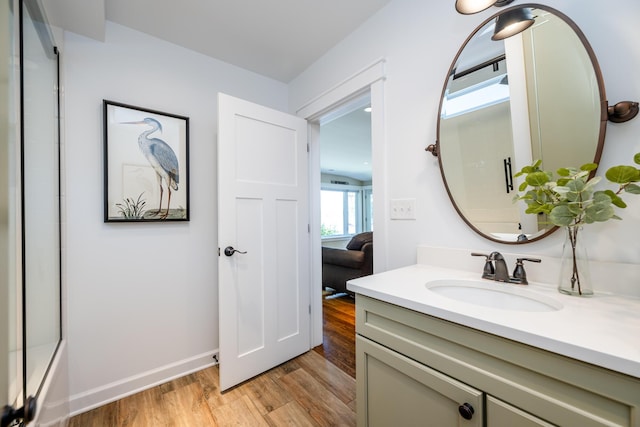 7881 Lakewood Dr, Coloma, MI 49038 - full bath with wood finished floors, vanity, and baseboards