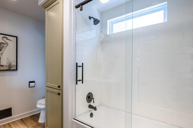 7881 Lakewood Dr, Coloma, MI 49038 - full bathroom with toilet, baseboards, wood finished floors, and shower / bath combination with glass door