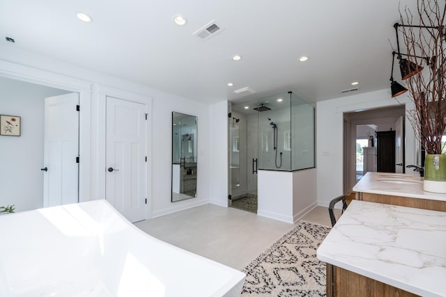 7881 Lakewood Dr, Coloma, MI 49038 - full bathroom featuring a stall shower, recessed lighting, vanity, baseboards, and a freestanding bath