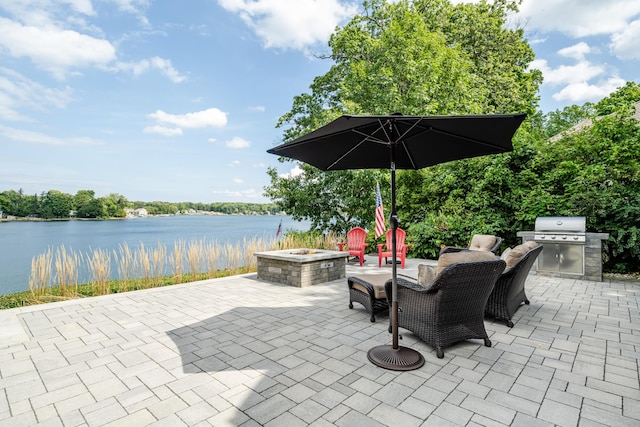 7881 Lakewood Dr, Coloma, MI 49038 - view of patio with an outdoor fire pit and a water view