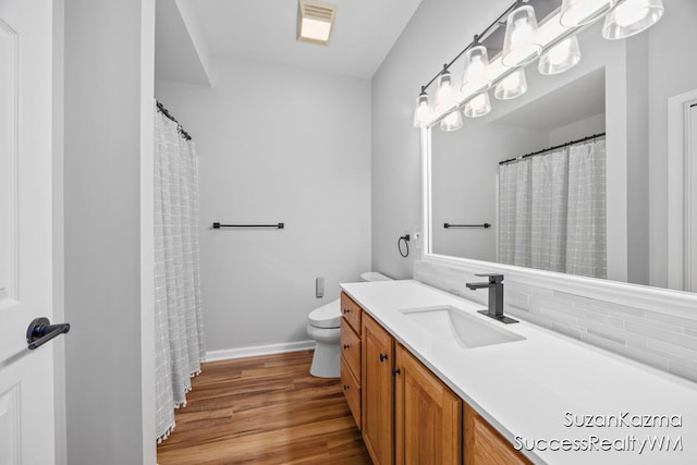 1323 Gleneagle Pl Unit 7, Hudsonville, MI 49426 - full bathroom with vanity, decorative backsplash, wood finished floors, toilet, and baseboards
