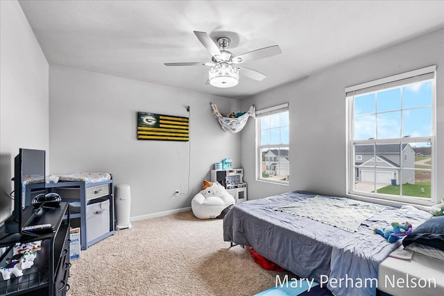 carpeted bedroom featuring ceiling fan and baseboards