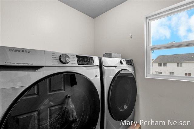 washroom featuring washer and clothes dryer and plenty of natural light