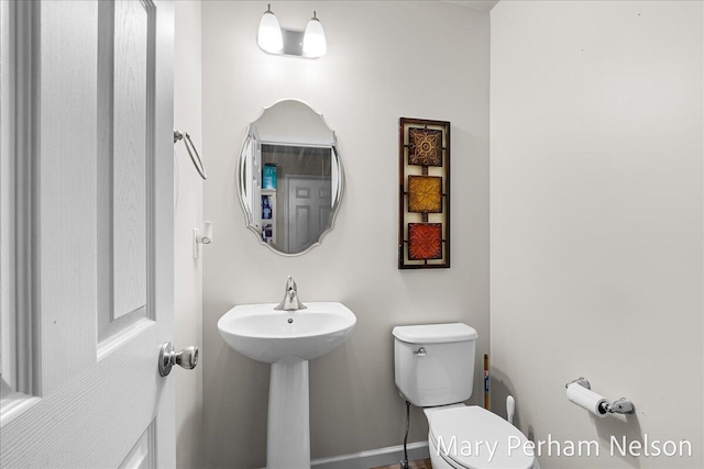 half bathroom featuring toilet