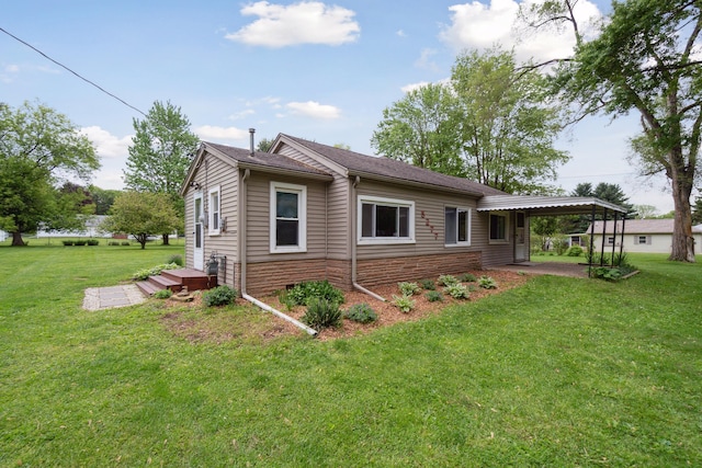 5277 Kay Dr, Jackson, MI 49203 - view of property exterior featuring a yard, an attached carport, and a patio