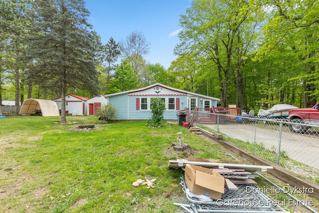 11660 Wren Dr, Lakeview, MI 48850 - rear view of property featuring an outdoor fire pit and a wooden deck