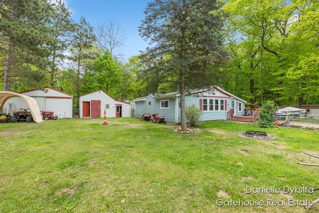 11660 Wren Dr, Lakeview, MI 48850 - view of yard with an outbuilding, an outdoor fire pit, a pole building, and a detached garage