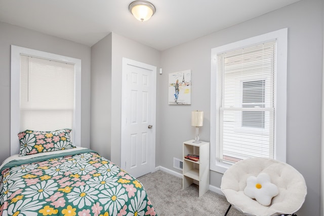 1426 Canton St, Detroit, MI 48207 - bedroom featuring light carpet, multiple windows, and baseboards