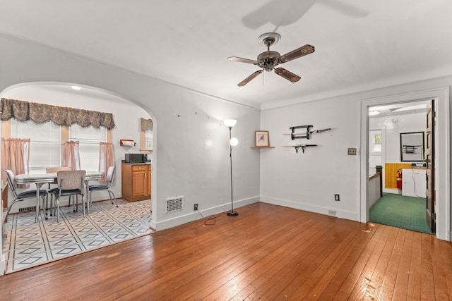 449 Spruce St, Wyandotte, MI 48192 - living area with light wood-type flooring, a ceiling fan, and plenty of natural light