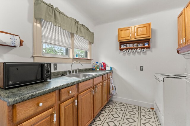 449 Spruce St, Wyandotte, MI 48192 - kitchen with black microwave, a sink, dark countertops, baseboards, and brown cabinets