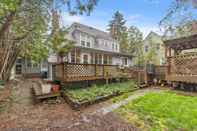 449 Spruce St, Wyandotte, MI 48192 - rear view of property featuring a wooden deck, a chimney, and a sunroom