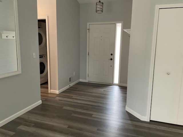 6561 Deerhurst Dr, Westland, MI 48185 - entryway featuring stacked washer / dryer, baseboards, and dark wood finished floors