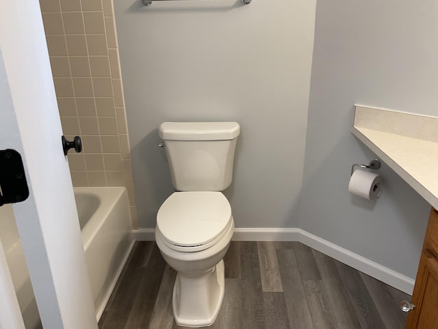 6561 Deerhurst Dr, Westland, MI 48185 - bathroom with wood finished floors, toilet, vanity, and baseboards