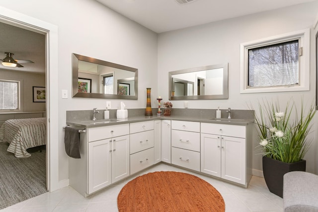 7361 N Shore Dr, South Haven, MI 49090 - full bathroom with tile patterned flooring, double vanity, ceiling fan, and baseboards