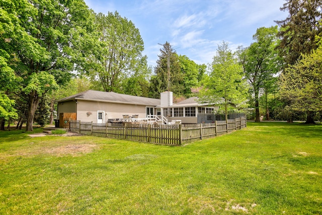7361 N Shore Dr, South Haven, MI 49090 - rear view of house featuring a sunroom, a chimney, and view of wooded area