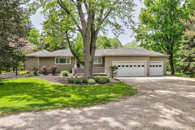 7361 N Shore Dr, South Haven, MI 49090 - ranch-style home featuring driveway, an attached garage, and a front yard