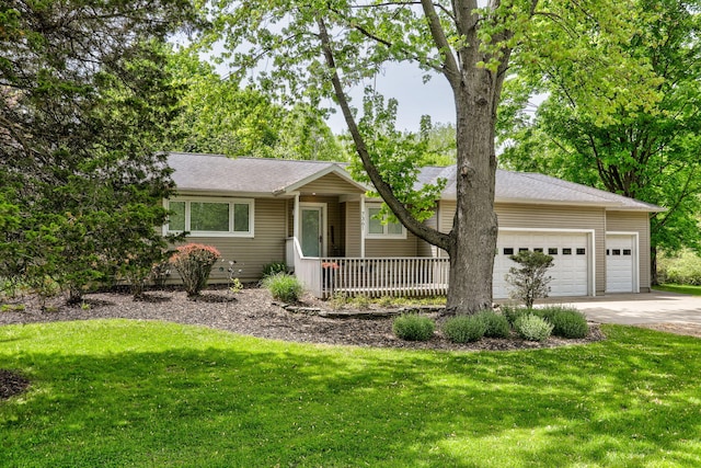 7361 N Shore Dr, South Haven, MI 49090 - single story home with concrete driveway, an attached garage, a front lawn, and covered porch