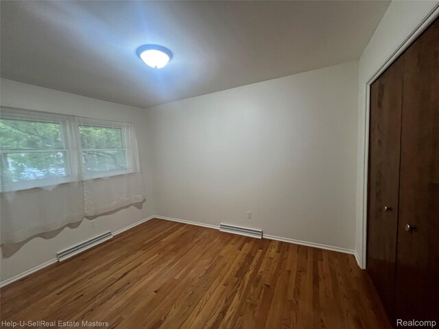 1420 Jones, Port Huron, MI 48060 - unfurnished bedroom featuring wood finished floors, baseboards, and a closet