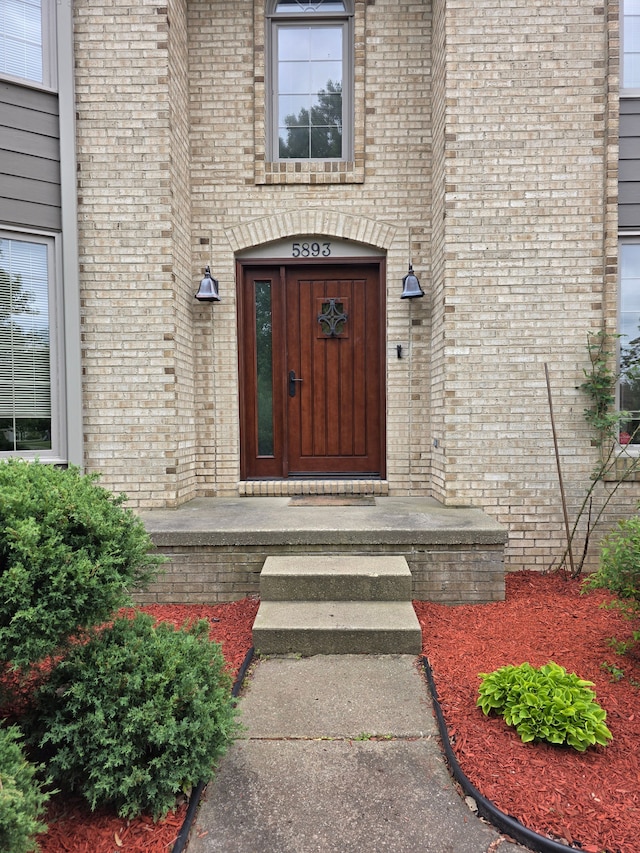 5893 Christina Dr, West Bloomfield, MI 48324 - view of exterior entry featuring brick siding