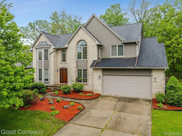 5893 Christina Dr, West Bloomfield, MI 48324 - view of front of house with brick siding, driveway, roof with shingles, and a garage
