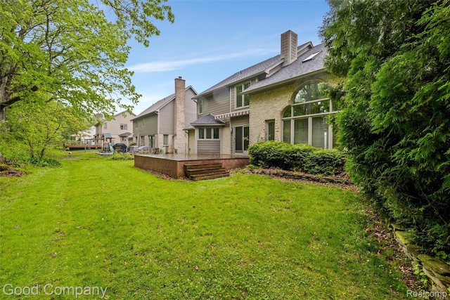 5893 Christina Dr, West Bloomfield, MI 48324 - rear view of property with a yard, brick siding, a wooden deck, and a chimney