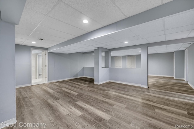 5893 Christina Dr, West Bloomfield, MI 48324 - finished basement with a drop ceiling, wood finished floors, and baseboards