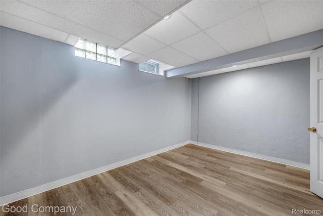 5893 Christina Dr, West Bloomfield, MI 48324 - below grade area with wood finished floors, baseboards, and a drop ceiling